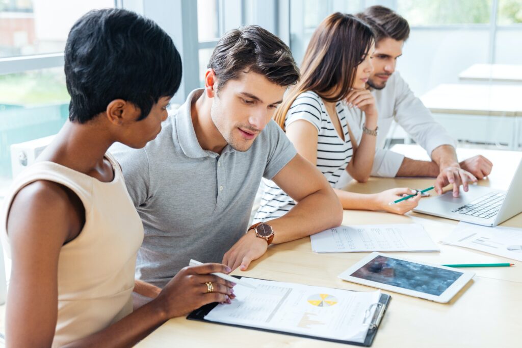 Multiethnic group of people creating business plan in office